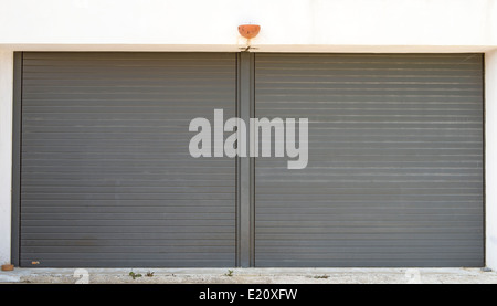 Gray garage doors with a cross on the top Stock Photo