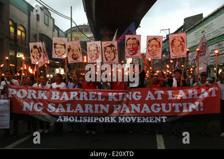 Manila, Philippines. 12th June, 2014. Protesters holding torches while marching towards Mendiola, Manila Several hundred protesters held different protest rallies all over Metro Manila marking the Philippines' 116th Independence Day. Different groups called for accountability and transparency regarding the corruption scandals of high ranking government officials. The protesters also called for the ouster of President Aquino for his alleged incompetency in governing his administration. Credit:  PACIFIC PRESS/Alamy Live News Stock Photo