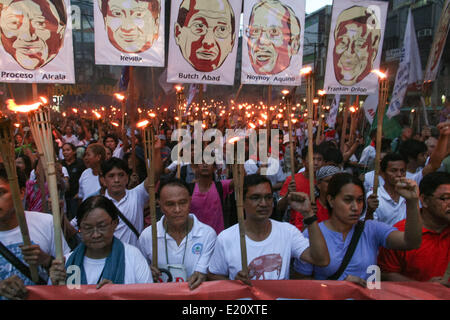 Manila, Philippines. 12th June, 2014. Protesters holding torches while marching towards Mendiola, Manila. Several hundred protesters held different protest rallies all over Metro Manila marking the Philippines' 116th Independence Day. Different groups called for accountability and transparency regarding the corruption scandals of high ranking government officials. The protesters also called for the ouster of President Aquino for his alleged incompetency in governing his administration. Credit:  PACIFIC PRESS/Alamy Live News Stock Photo