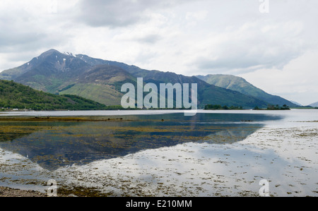 View across calm sea Loch Leven to mountains at high tide from Invercoe, Glencoe, Highland, Scotland, UK, Britain Stock Photo