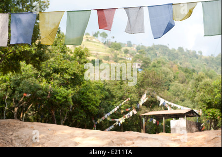 Multi colored prayer flags in Himalayan mountain range in Nepal Stock Photo