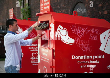 Donation Point; Man (MR) Shoe recycling charities; reuse donation' preloved clothing charity clothes donate giving charitable used container give secondhand poor need support welfare collection give donated shoes in Manchester, UK Stock Photo