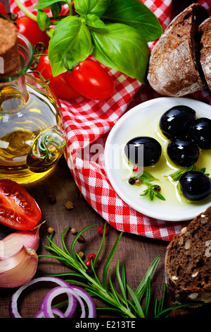 Olives and Olive Oil on an old table - italian food concept Stock Photo