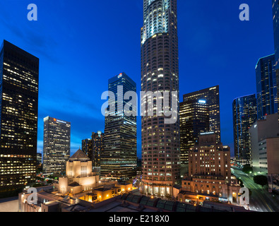 Downtown city skyline at night with US Bank Tower in centre and Central Library in foreground, Los Angeles, California, USA Stock Photo