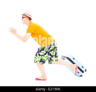 young backpacker pulling a baggage to travel worldwide Stock Photo