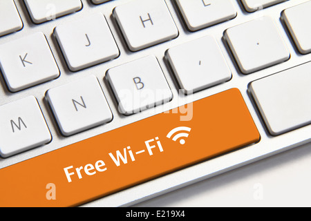 Photo of free wi-fi button on the white keyboard. Stock Photo
