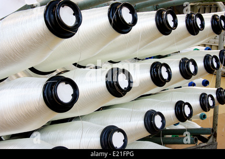 Bobbins weaver's manufacture. Of these strings make a cloth Stock Photo