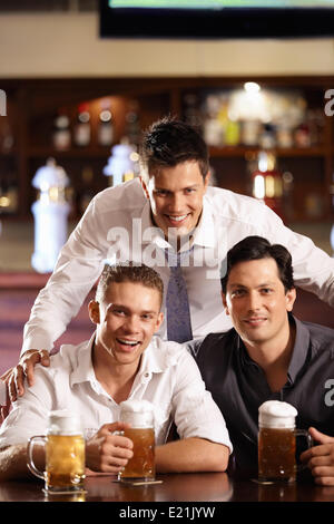 Three happy young men in the bar Stock Photo