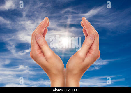 hands over blue sky Stock Photo