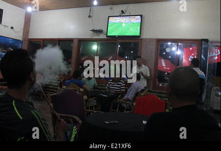 Gaza, Gaza Strip, Palestinian Territory. 12th June, 2014. Palestinians watch the opening match of the 2014 FIFA World Cup between Brazil and Croatia being played at the Corinthians Arena in Sao Paulo, at a cafe in Gaza City on June 12, 2014. The FIFA World Cup 2014 will take place in Brazil from 12 June to 13 July 2014 Credit:  Mohammed Asad/APA Images/ZUMAPRESS.com/Alamy Live News