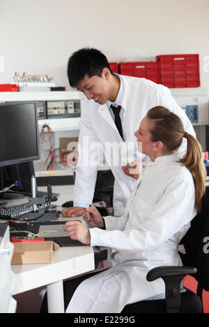 Two lab technicians discussing their work Stock Photo