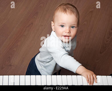 child  play music on piano keyboard Stock Photo