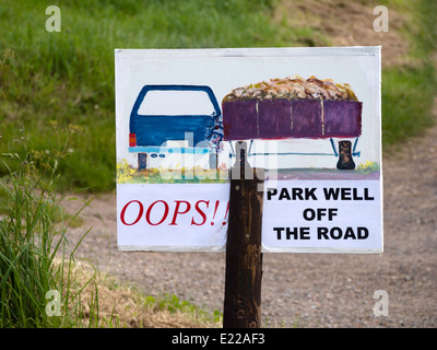 Warning sign advising drivers to park well off the road to avoid damage by passing wide agricultural vehicles Stock Photo