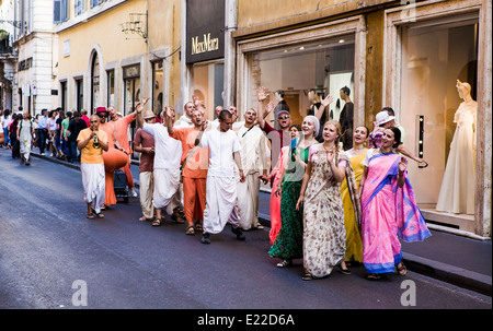 Hare Krishna followers singing and dancing in Rome's most fashionable street, Via Condotti. Stock Photo