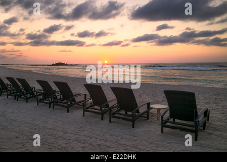 Sunset on beach with beach chairs at Punta Mita, Mexico. Stock Photo