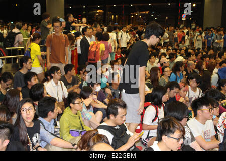 Hong Kong. 13th June 2014. Demonstrators opposed to the development of two new towns in the New Territories take part in a sit-down protest outside the Legislative Council Building in Tamar, Hong Kong. Credit:  Robert SC Kemp/Alamy Live News Stock Photo