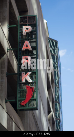 Neon Parking Sign At Parking Garage In City Downtown Stock Photo