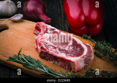 meat, vegetables and spices on wooden background Stock Photo