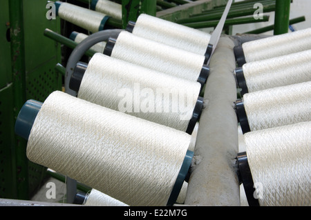 Bobbins weaver's manufacture. Of these strings make a cloth Stock Photo