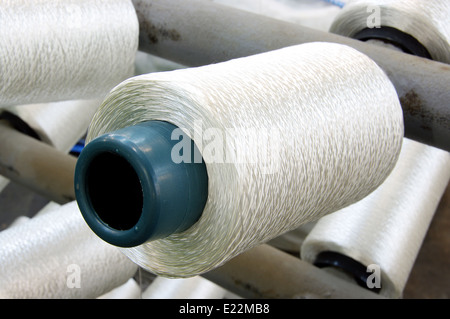 Bobbins weaver's manufacture. Of these strings make a cloth Stock Photo