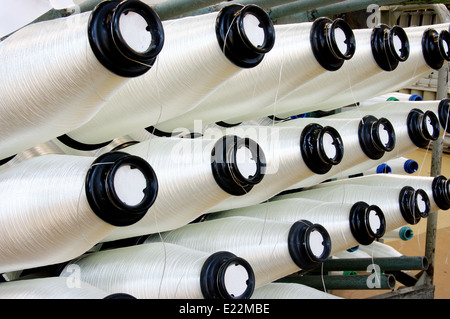 Bobbins weaver's manufacture. Of these strings make a cloth Stock Photo