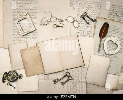 vintage writing accessories, glasses, keys, open book, old papers, letters and photo frames. documents and manuscripts Stock Photo