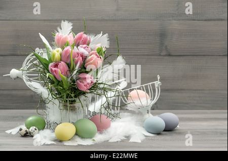 easter composition with eggs and pastel tulip flowers. nostalgic home interior. retro style colored picture