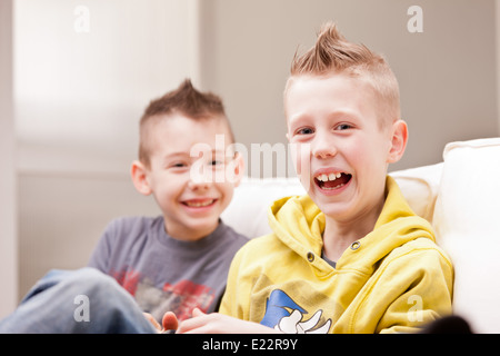 two little boys having lots of fun with video games Stock Photo