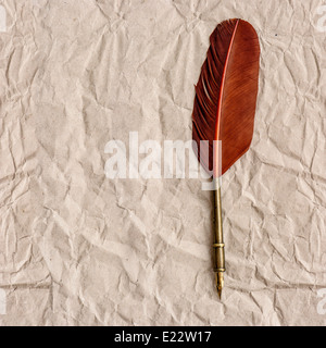 aged paper with antique ink feather pen. vintage background with space for your text Stock Photo
