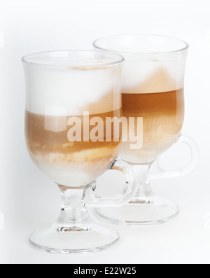 Two glass mugs with handles of latte coffee, macro photo Stock Photo