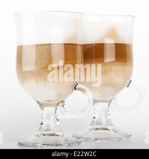 Two big glass mugs with handles of latte coffee, macro photo Stock Photo