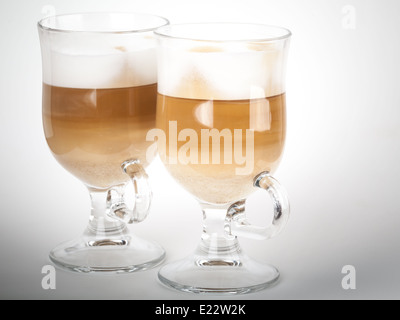 Two glass mugs with handles of latte coffee Stock Photo