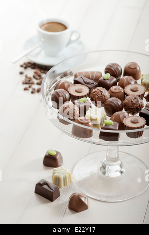 assorted chocolates confectionery on tray with cup of coffee Stock Photo