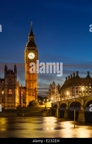 Long exposure night shot of the Houses of Parliament in London with blue sky and the Westminster Bridge in the foreground. Stock Photo