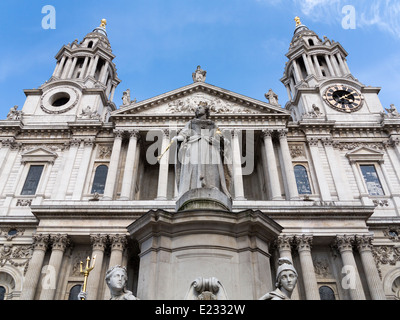 Low angle of front facade of St Paul's Cathedral with statue of Queen Victoria in foreground, no dome showing Stock Photo