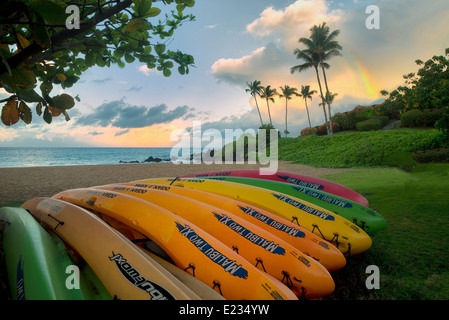 Kayaks on beach with rainbow. Maui, Hawaii Stock Photo