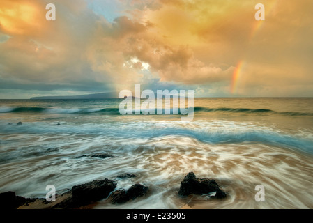 Maui coast with waves and rainbow with light and rain on Molokini. Hawaii Stock Photo