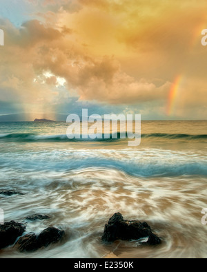Maui coast with waves and rainbow with light and rain on Molokini. Hawaii Stock Photo