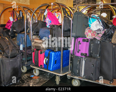 Luggage Carts Stacked with Suitcases in a Hotel Lobby Stock Photo