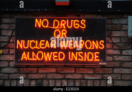 Neon sign on nightclub wall in Brighton saying No Drugs or Nuclear Weapons Allowed Inside Stock Photo