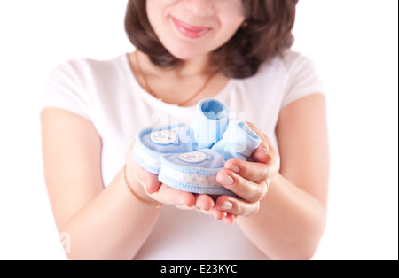 Woman hand with baby shoes Stock Photo