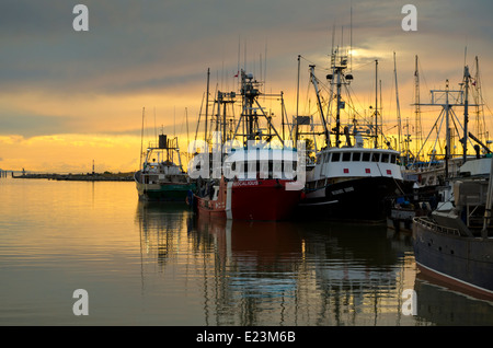 Fishing boats and Canadian Coast guard vessel in Steveston harbour at sunset. Fraser River, Richmond, British Columbia, Canada Stock Photo