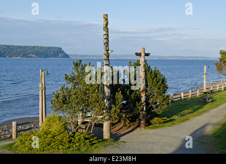 First Nations or Native American  totem poles located along the water in Langley, Washington State, on Whidbey Island. Stock Photo