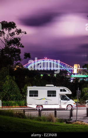 A motor-home camping in Mort Bay, Balmain in Sydney photographed against the backdrop of the Sydney Harbour Bridge Stock Photo