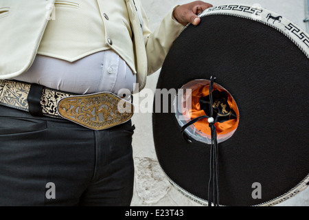 Cowboy belt buckle and sombrero of a Mexican mariachi dressed in traditional charro costume November 5, 2013 in Oaxaca, Mexico. Stock Photo