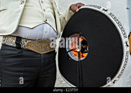 Cowboy belt buckle and sombrero of a Mexican mariachi dressed in traditional charro costume November 5, 2013 in Oaxaca, Mexico. Stock Photo