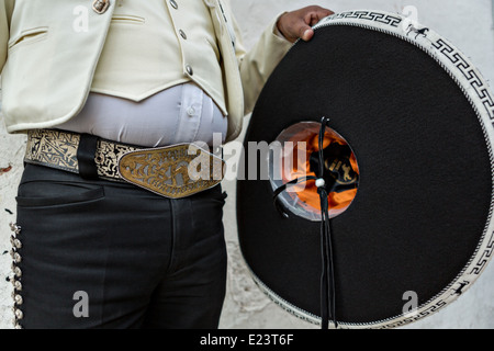 Cowboy belt buckle and sombrero of a Mexican mariachi dressed in traditional charro costume November 5, 2013 in Oaxaca, Mexico. Stock Photo