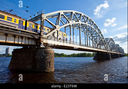 A train traveling across the Iron Bridge over the Daugava River in Riga, Latvia. Stock Photo