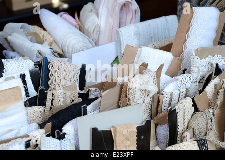 Paris fleamarket,  Les Puces de Saint-Ouen, showing lace and other stuff for sewing Stock Photo