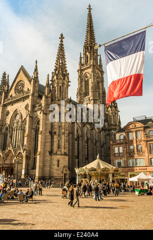 view of st stephen´s church at place de la reunion, on the right a french flag, in the background a historical merry-go-round Stock Photo